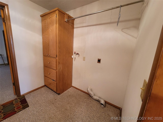 laundry area featuring light carpet, cabinet space, baseboards, and electric dryer hookup