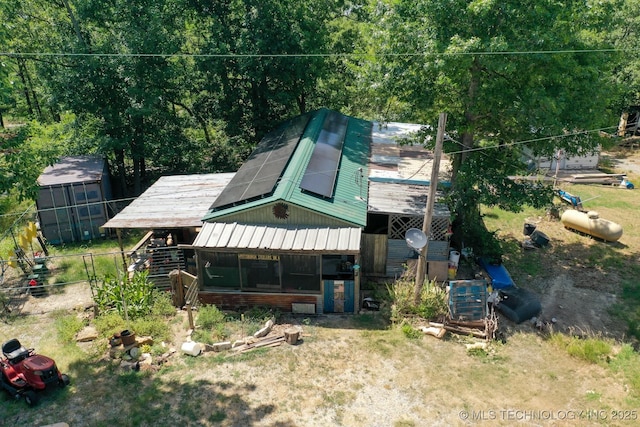 view of front of home with metal roof and solar panels