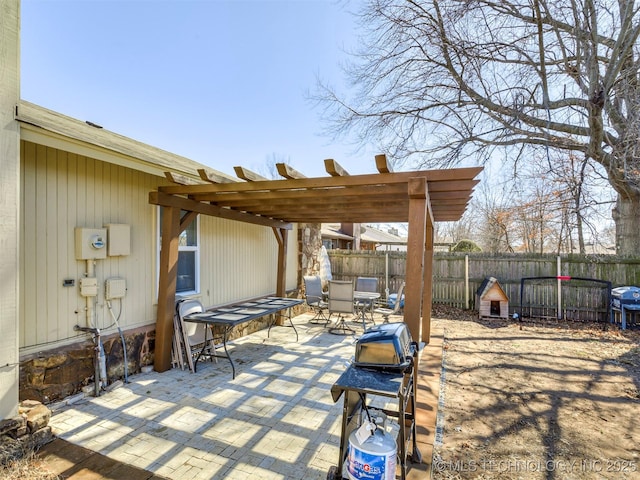 view of patio featuring outdoor dining space, fence, and a pergola