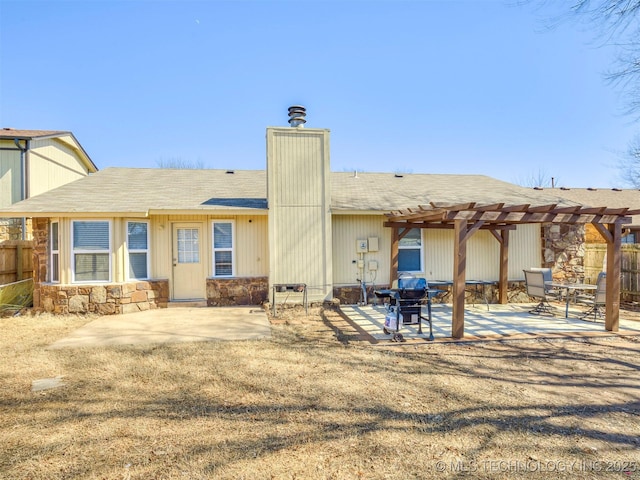 rear view of property with a patio, a chimney, fence, and a pergola