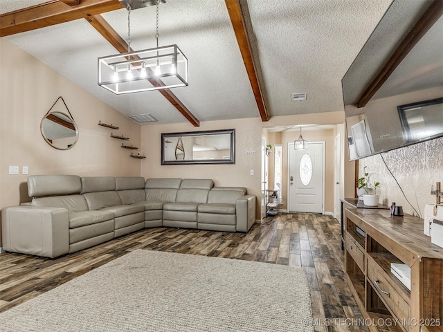 unfurnished living room featuring vaulted ceiling with beams, visible vents, dark wood finished floors, and a textured ceiling