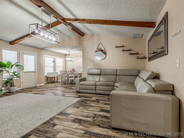 living room with baseboards, visible vents, wood finished floors, vaulted ceiling with beams, and a textured ceiling