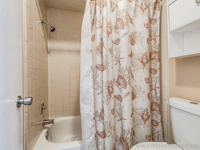 bathroom featuring shower / bath combination with curtain, a textured ceiling, and toilet