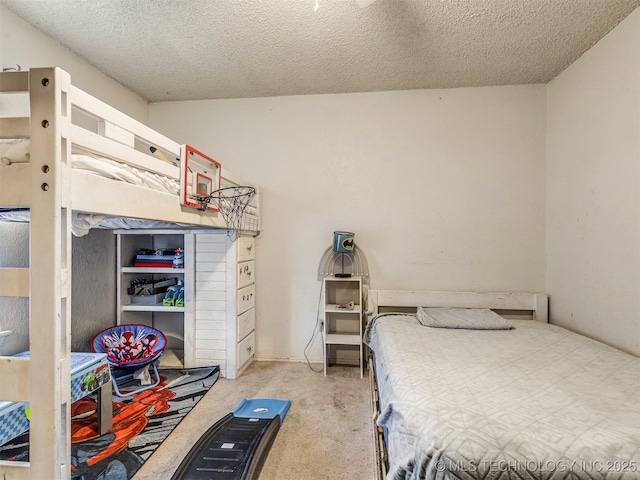 bedroom featuring carpet and a textured ceiling