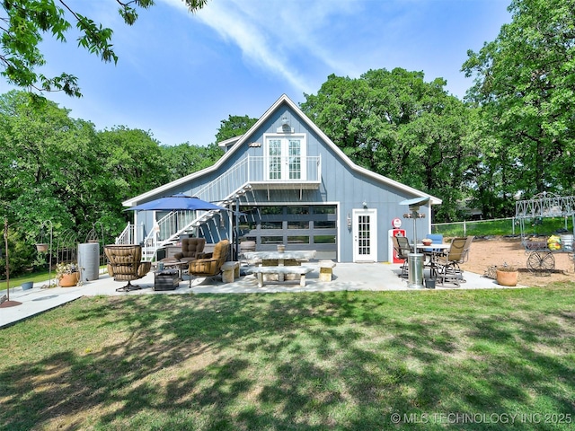 rear view of property featuring french doors, a patio, stairs, fence, and a yard