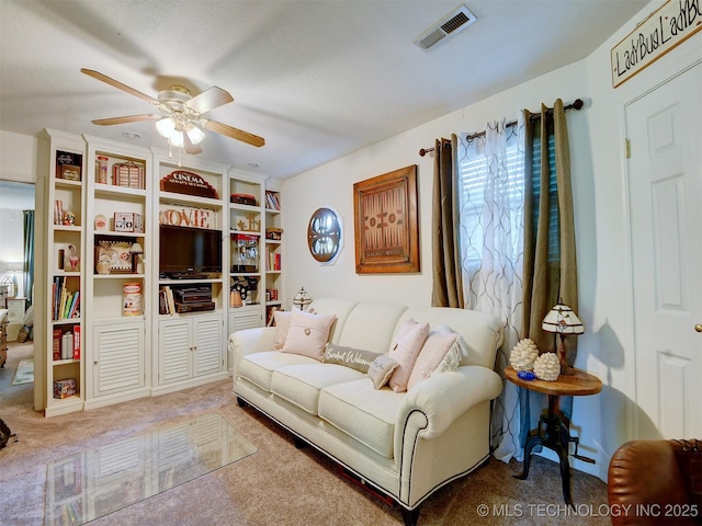 carpeted living room featuring visible vents and a ceiling fan