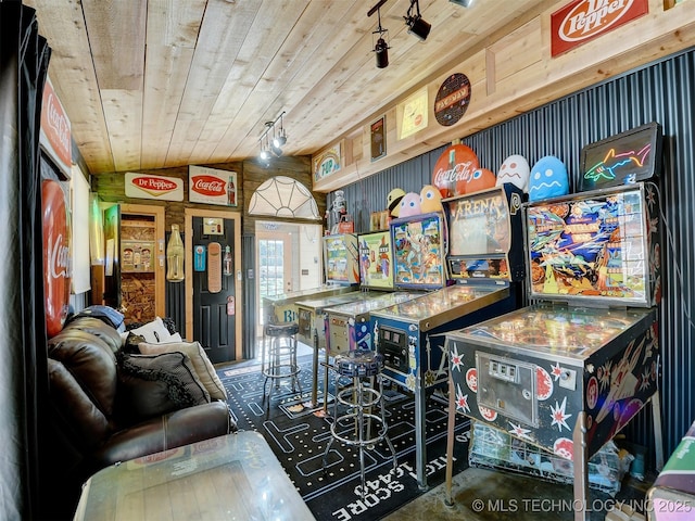 recreation room with wooden ceiling, vaulted ceiling, and wood walls