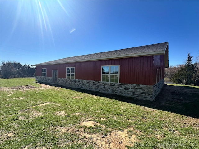 view of home's exterior featuring a yard and stone siding