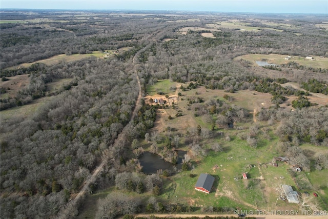 birds eye view of property with a forest view