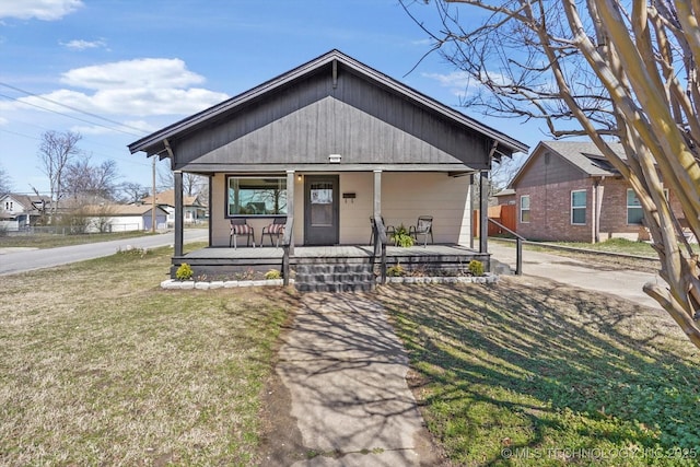 view of front of property with covered porch and a front lawn