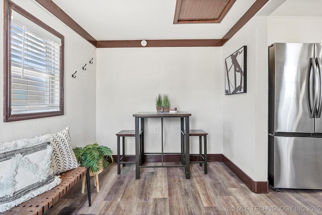 sitting room with baseboards and wood finished floors