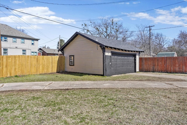 detached garage featuring fence