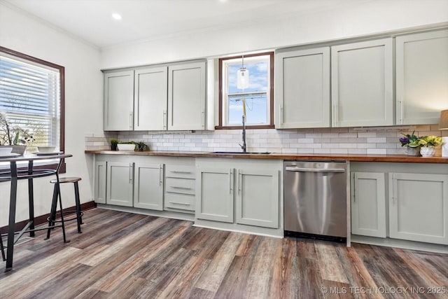 kitchen featuring gray cabinets, decorative backsplash, ornamental molding, a sink, and dishwasher