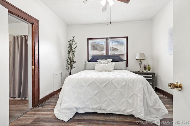 bedroom with a ceiling fan, baseboards, dark wood finished floors, and crown molding