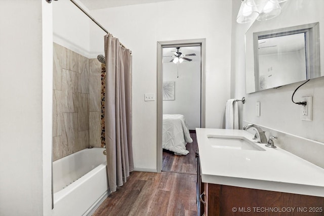 ensuite bathroom featuring ensuite bathroom, wood finished floors, vanity, and shower / tub combo with curtain