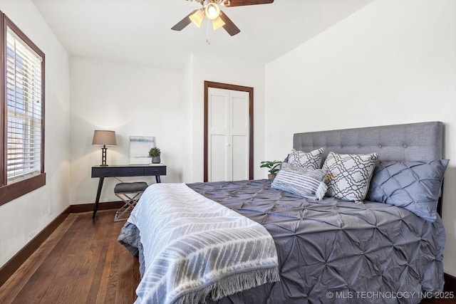 bedroom featuring wood finished floors, a ceiling fan, and baseboards