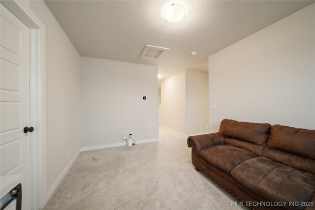 living area with carpet floors, attic access, and baseboards