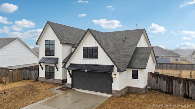 view of front of house with a standing seam roof, fence, and roof with shingles