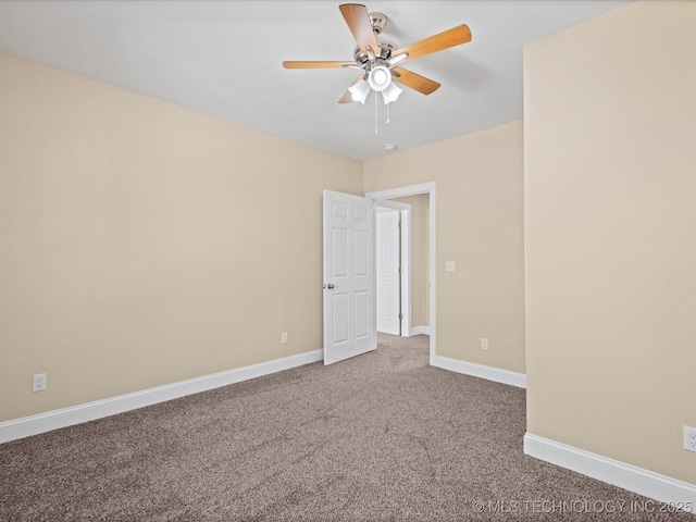 carpeted empty room with a ceiling fan and baseboards