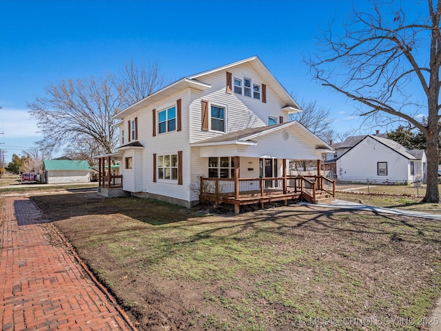 view of front of home featuring fence, a front lawn, and a wooden deck