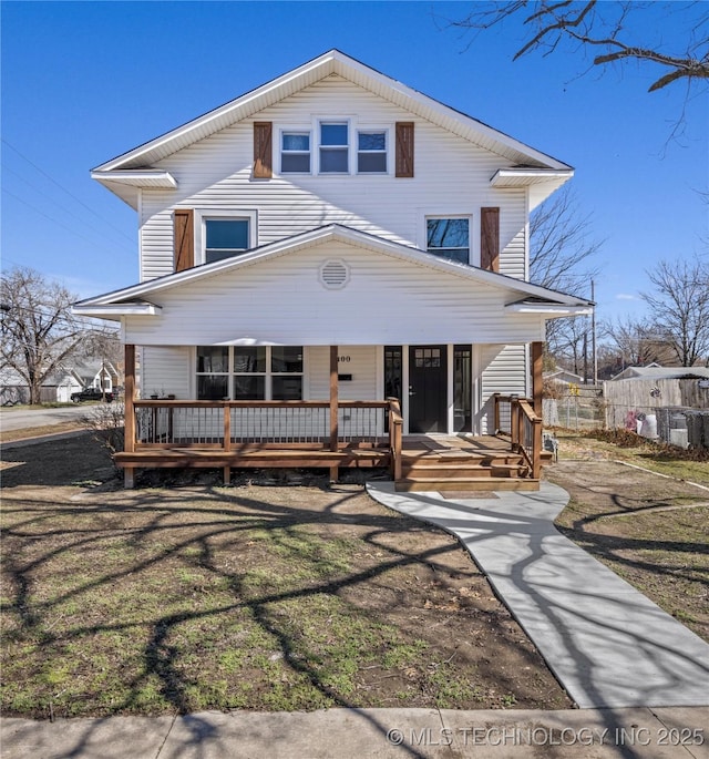 traditional style home featuring a porch and a front lawn