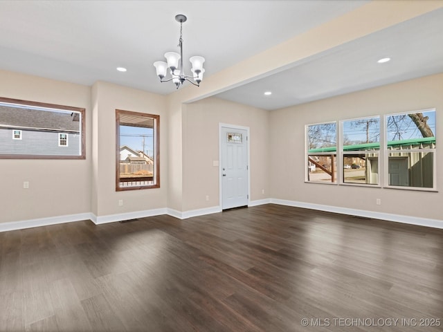 interior space featuring recessed lighting, baseboards, dark wood finished floors, and a chandelier