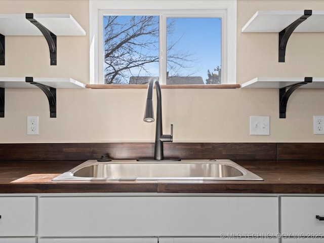 room details with a sink and white cabinetry