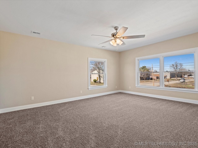 unfurnished room featuring a ceiling fan, carpet, visible vents, and baseboards