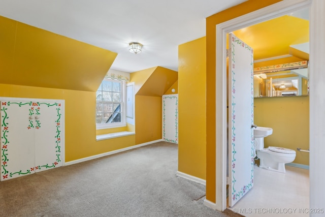 bonus room featuring lofted ceiling, carpet floors, and baseboards