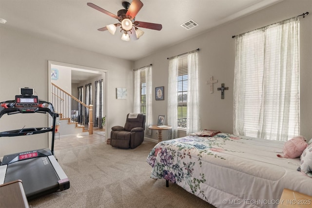 bedroom featuring baseboards, carpet, visible vents, and a ceiling fan