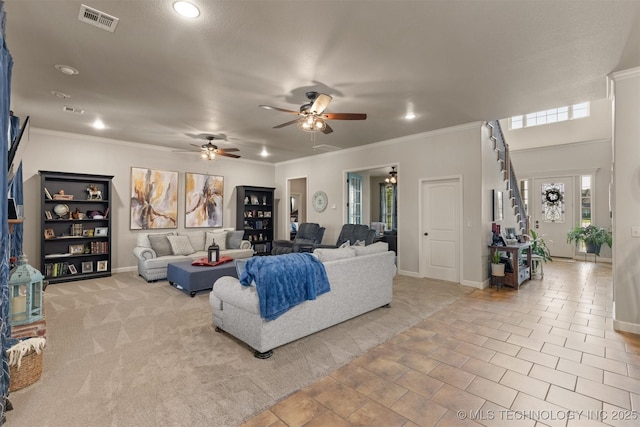 living area with light carpet, baseboards, visible vents, and crown molding