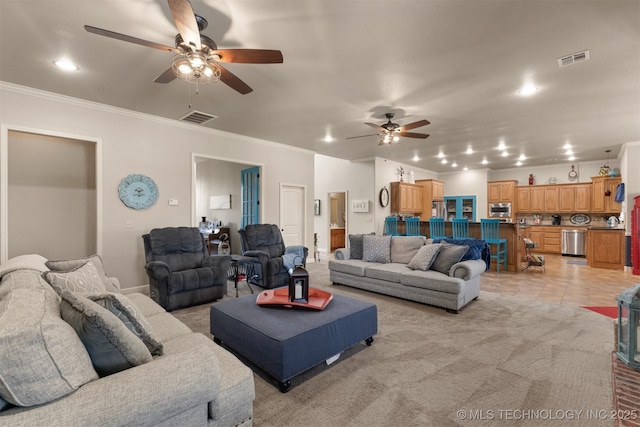 living area featuring ornamental molding, visible vents, and light colored carpet