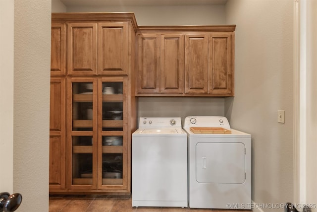 laundry room with cabinet space and washer and clothes dryer