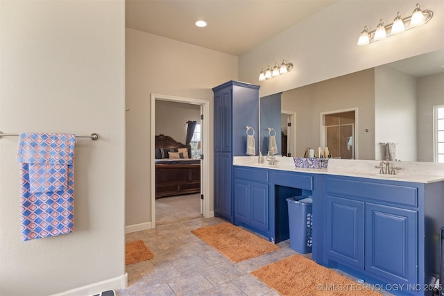 full bathroom featuring a sink, a shower stall, ensuite bathroom, and double vanity