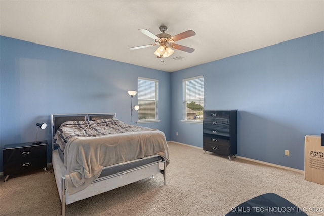 bedroom with carpet, visible vents, baseboards, and a ceiling fan