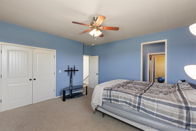 bedroom with a ceiling fan, a closet, and carpet flooring