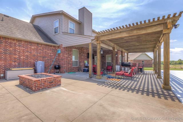 view of patio / terrace with an outdoor fire pit, fence, a pergola, and area for grilling