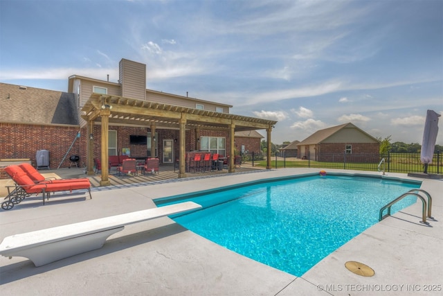 view of swimming pool featuring a fenced in pool, fence, a patio area, a diving board, and a pergola