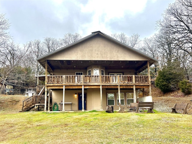 rear view of house featuring stairs, a yard, and a wooden deck