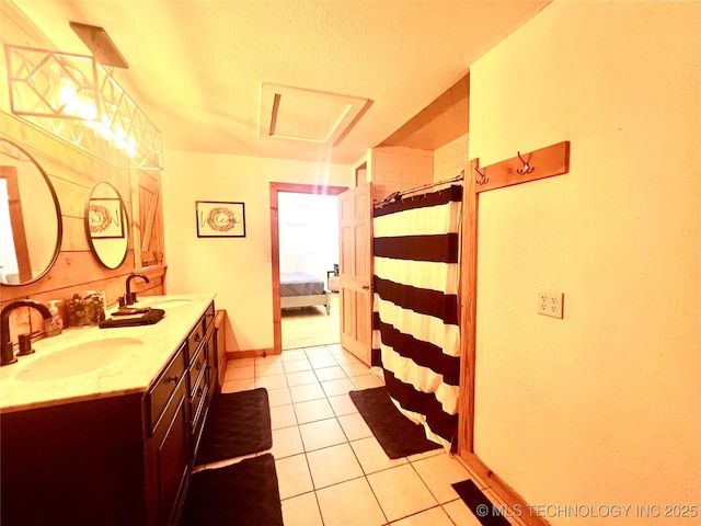 full bathroom with double vanity, curtained shower, a sink, and tile patterned floors