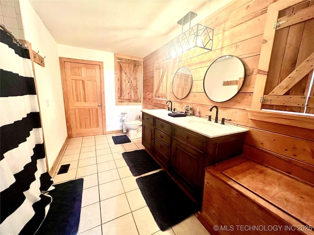 full bath with toilet, a sink, visible vents, tile patterned floors, and double vanity