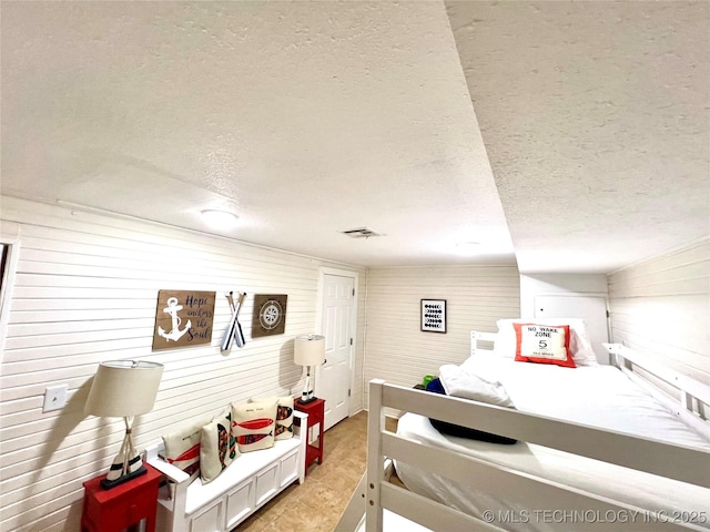 bedroom featuring a textured ceiling and visible vents