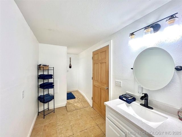 bathroom with baseboards and vanity