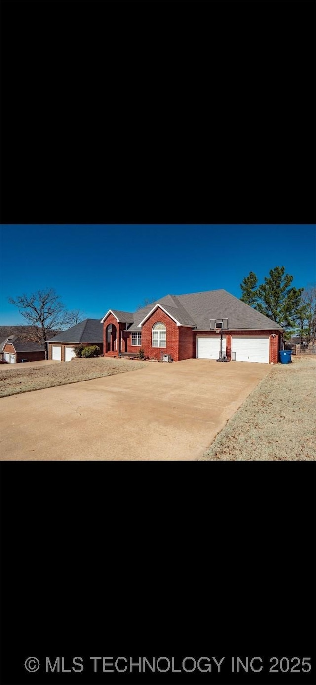 ranch-style home featuring a garage and concrete driveway