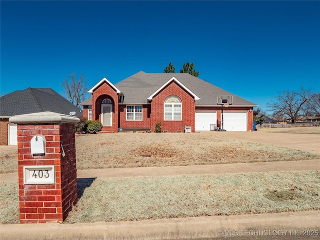 ranch-style house with a garage, brick siding, and driveway