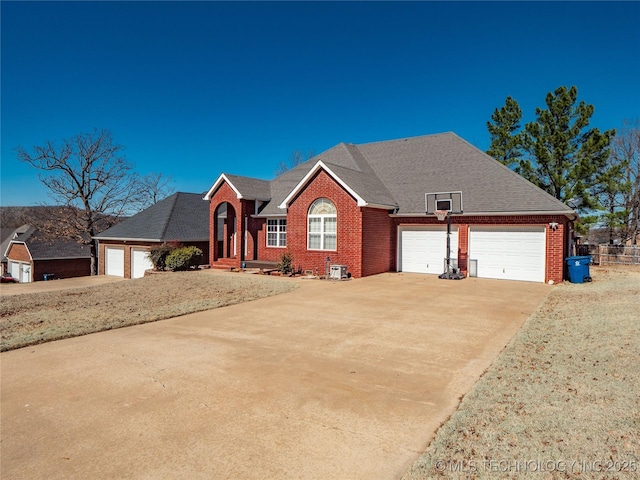 view of front of home featuring brick siding, driveway, and an attached garage