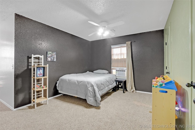 carpeted bedroom with a textured wall, ceiling fan, a textured ceiling, cooling unit, and baseboards