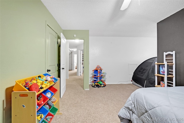 bedroom featuring carpet floors, baseboards, and a textured ceiling