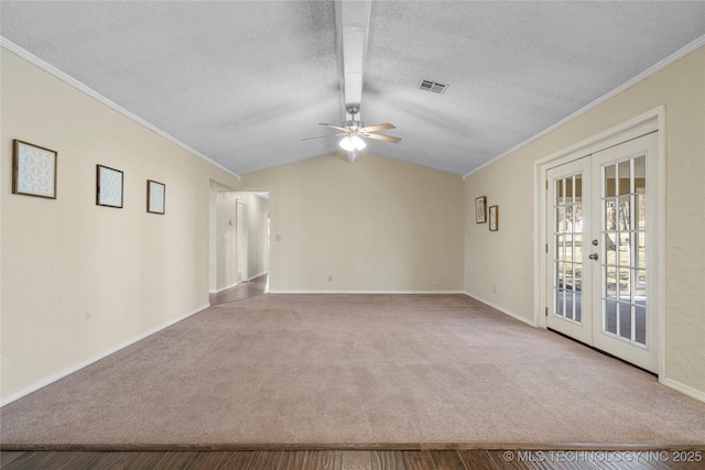 unfurnished room featuring carpet, french doors, crown molding, visible vents, and vaulted ceiling