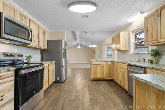 kitchen with stainless steel appliances, visible vents, a sink, and light brown cabinets